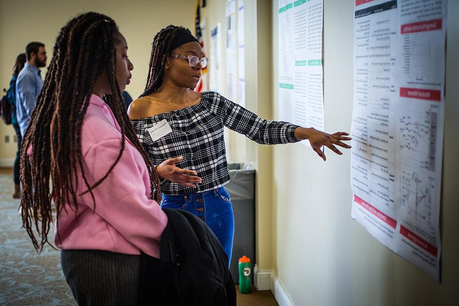 Students discuss a poster presentation during Northwest's 2022 Celebration of Scholars.